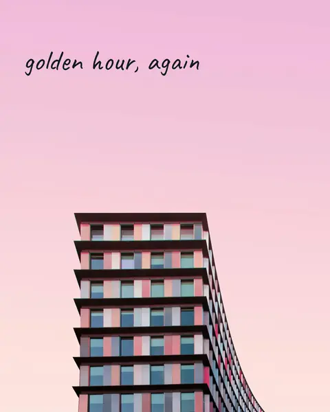 A pastel high-rise under a pink evening sky, with “golden hour, again” written in a script face across the sky