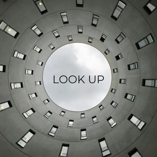 A circular concrete ceiling opening onto the sky, cropped square, with “Look up” set in the bright centre