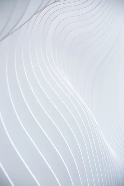 Fine white lines flowing across a curved surface