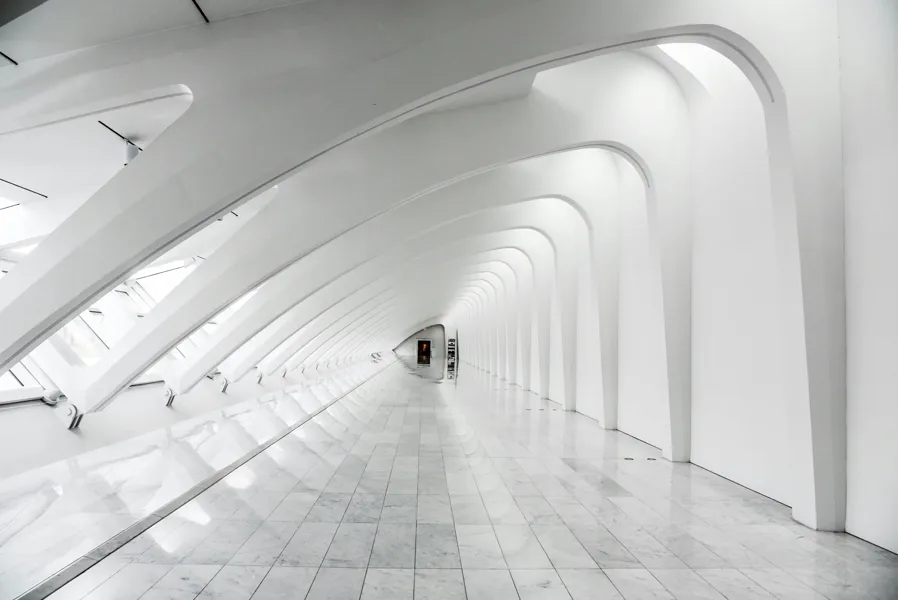 White ribbed vaults converging down a long hall