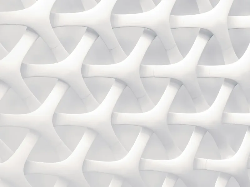 A facade of white sculpted panels folding into waves
